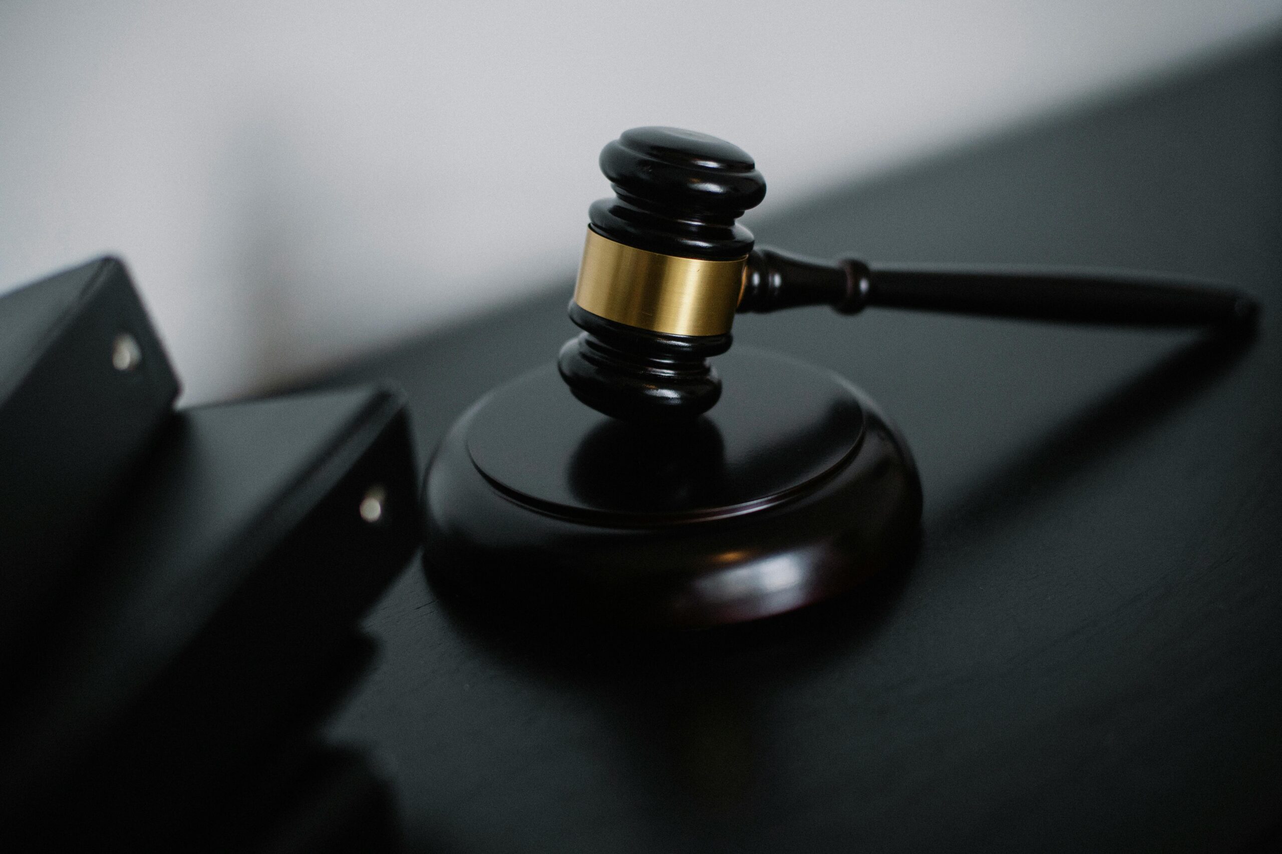 Close-up of a wooden gavel on a desk, symbolizing justice and legal authority.